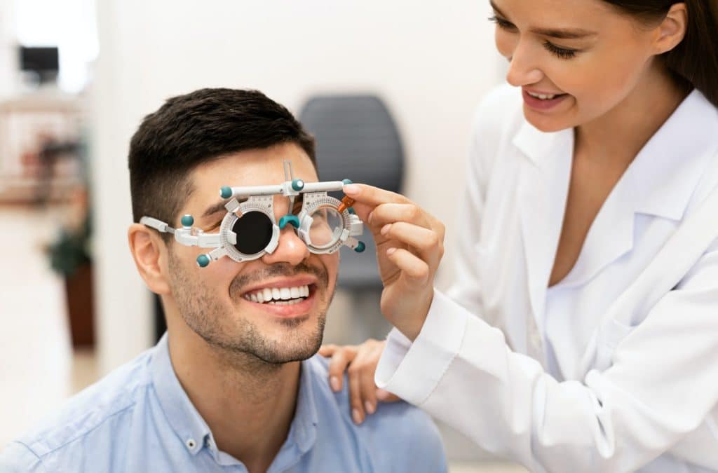 Ophthalmologist checking patients vision with trial frame