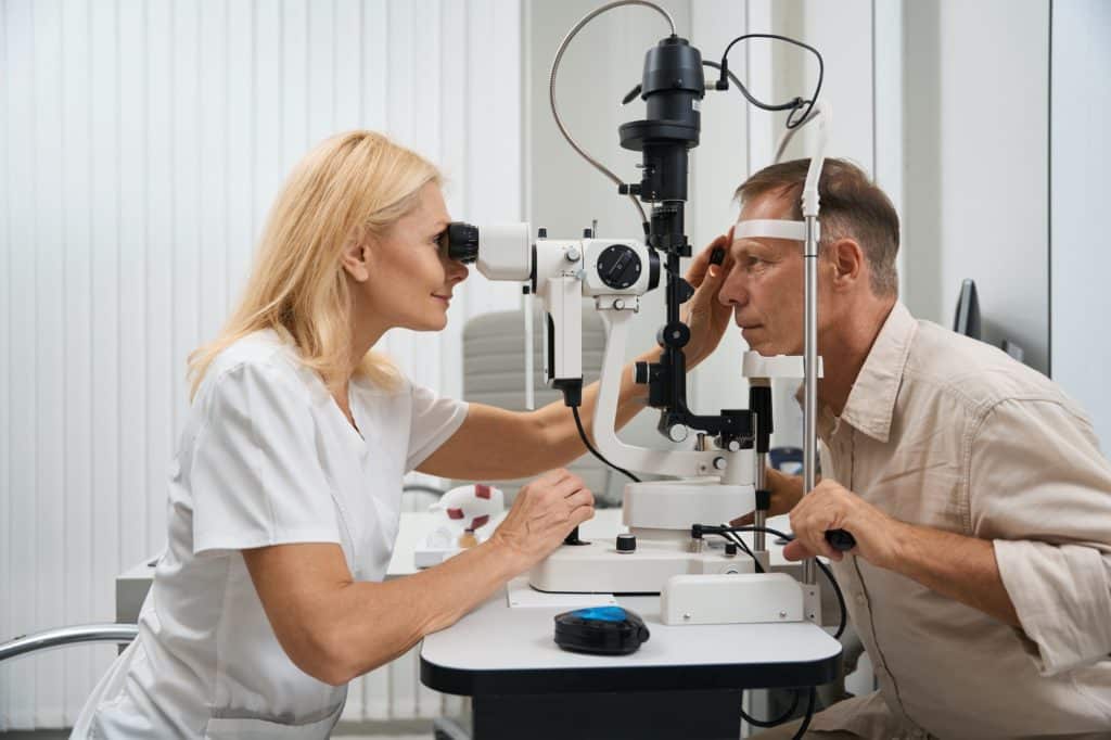 Ophthalmologist examining the eyeball of patient in cabinet