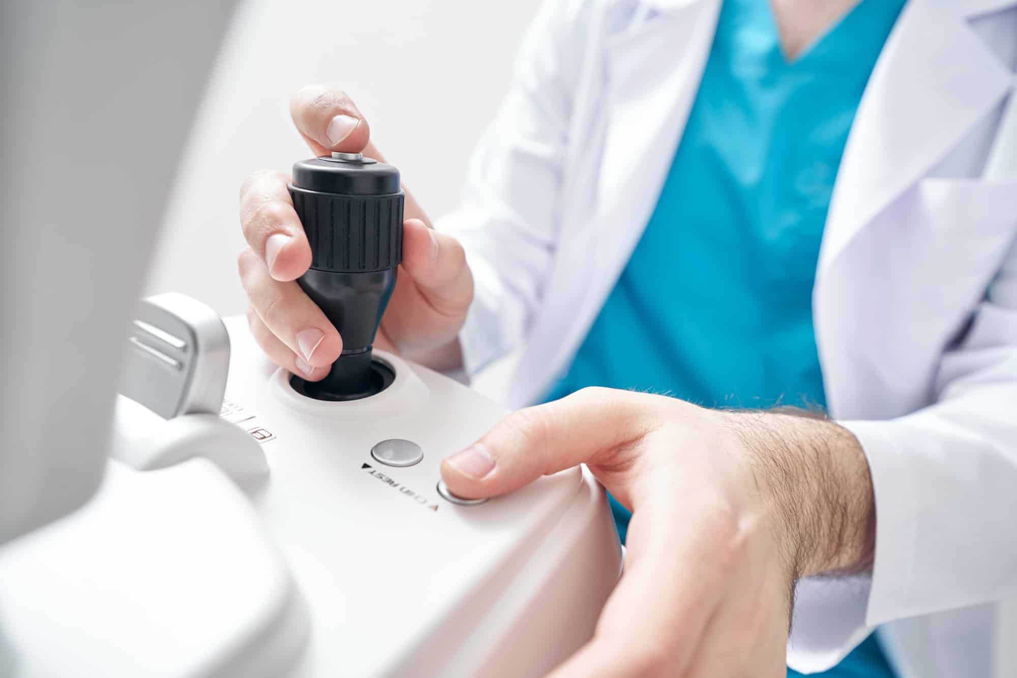 Ophthalmologist is working at the refraction machine